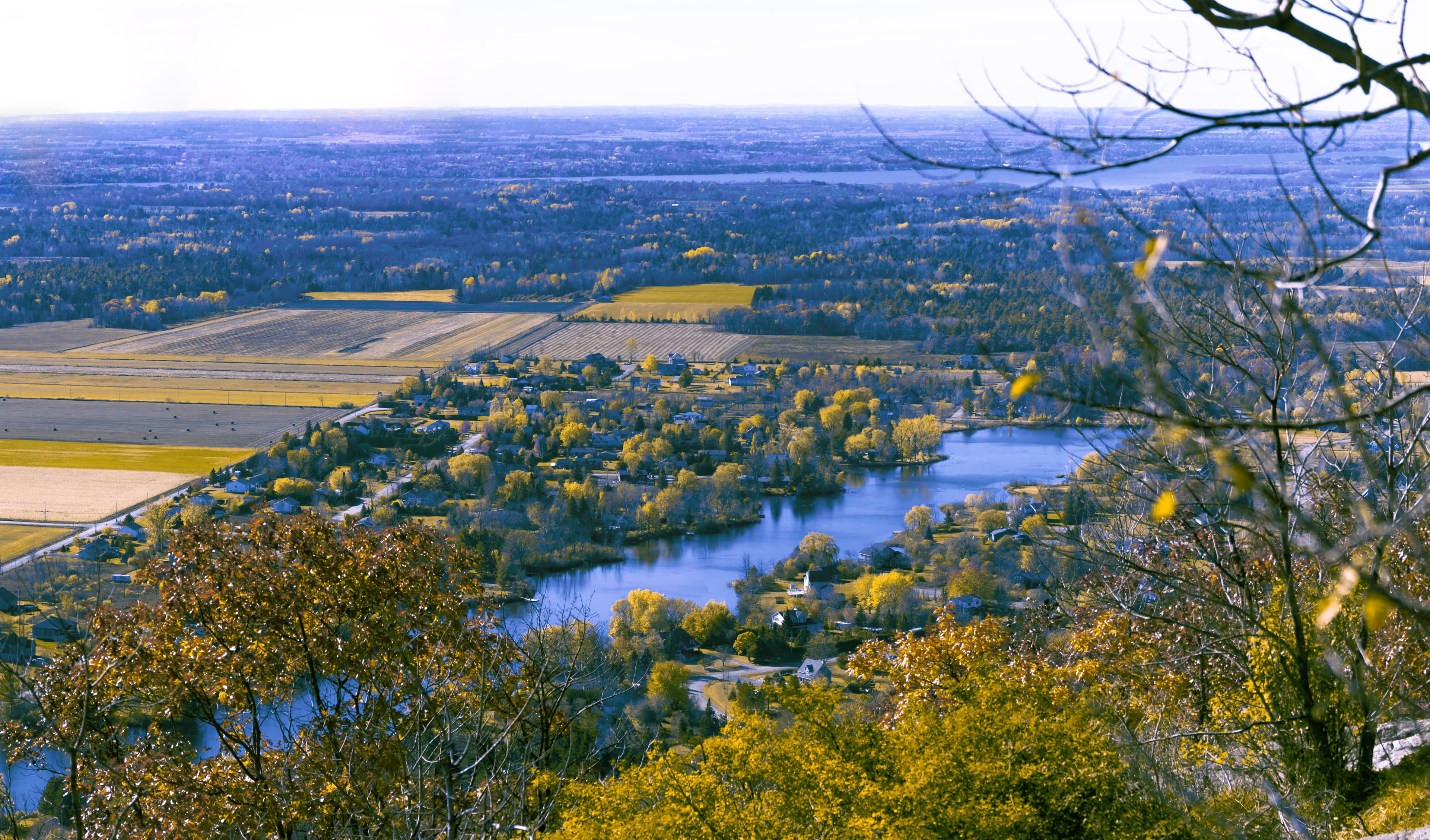 A colorful panoramic image of a neighborhood taken from the top of a mountain