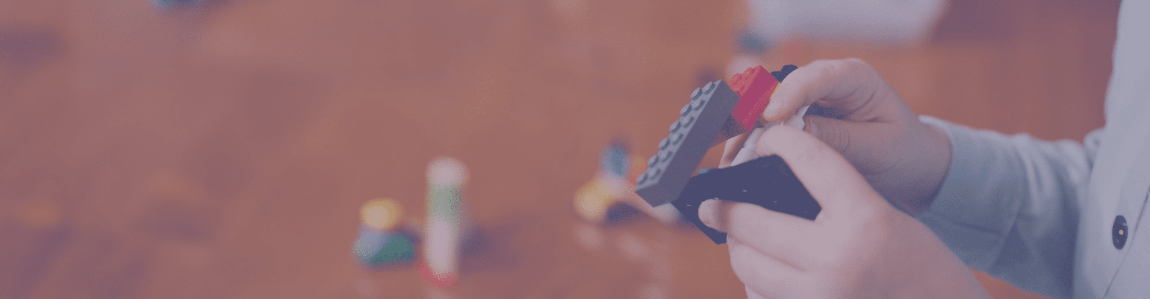 A banner image of a child playing with lego blocks
